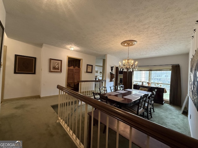 dining area with carpet flooring, a textured ceiling, and a chandelier