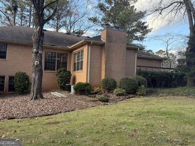 view of home's exterior featuring a yard and central AC unit