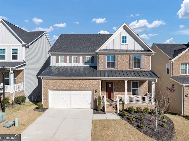 view of front of house featuring covered porch, a garage, and a front yard