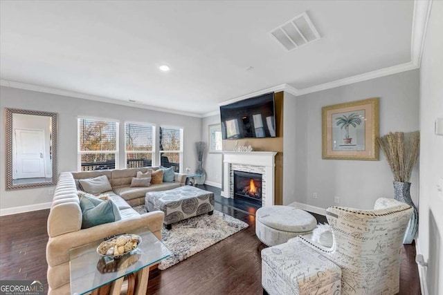 living area featuring baseboards, crown molding, visible vents, and dark wood-type flooring