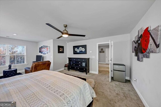 carpeted bedroom with refrigerator and ceiling fan