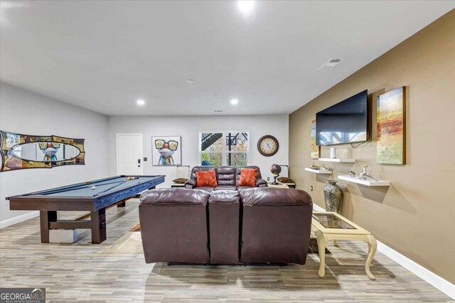 living room featuring light hardwood / wood-style floors and billiards