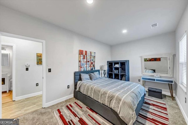 bedroom with carpet and ensuite bathroom