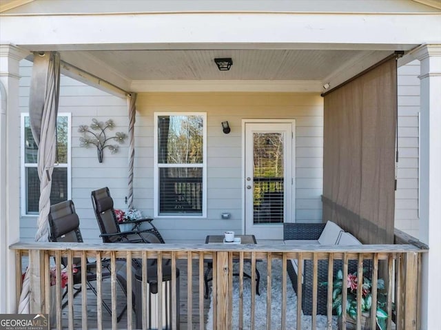 view of exterior entry featuring a wooden deck