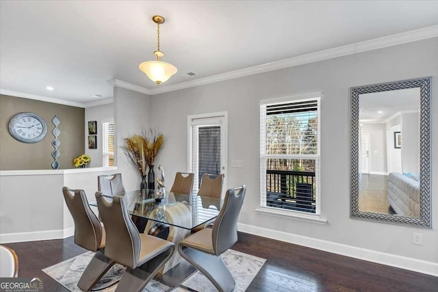 dining space with crown molding and dark hardwood / wood-style floors