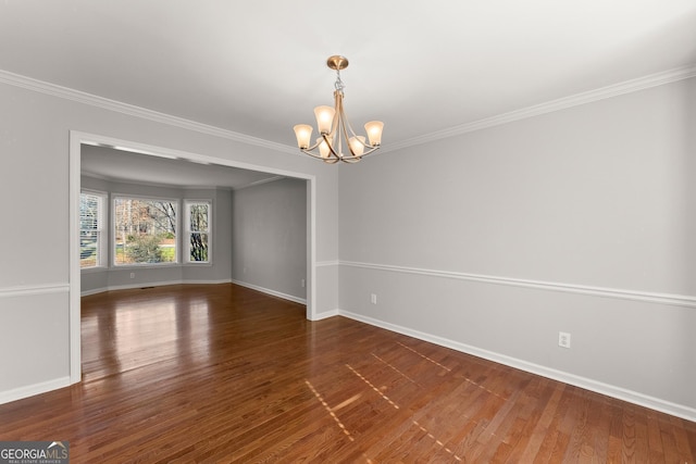 unfurnished room featuring dark hardwood / wood-style floors, crown molding, and an inviting chandelier