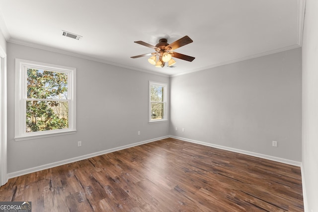 spare room with ceiling fan, dark wood-type flooring, and crown molding