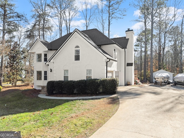 view of side of home with a yard