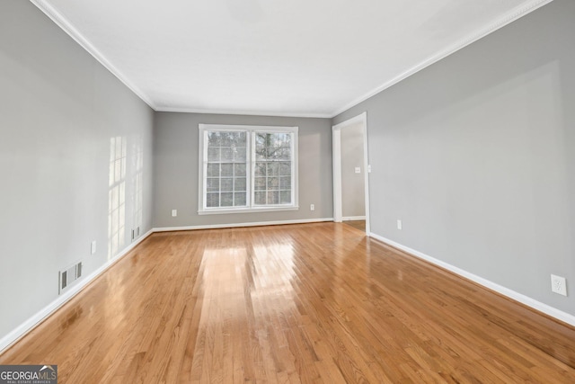 unfurnished room with light hardwood / wood-style floors and ornamental molding