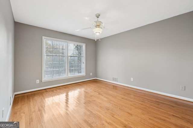 spare room featuring light wood-type flooring and ceiling fan