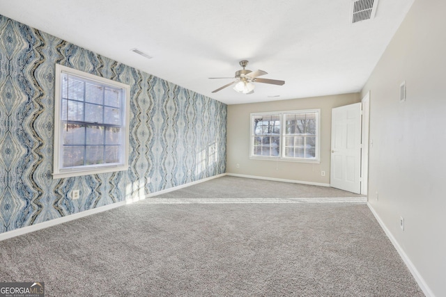 spare room featuring carpet floors and ceiling fan