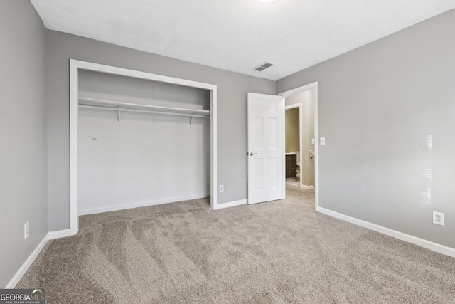 unfurnished bedroom featuring a closet and carpet