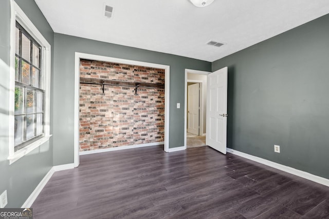 empty room with dark hardwood / wood-style floors