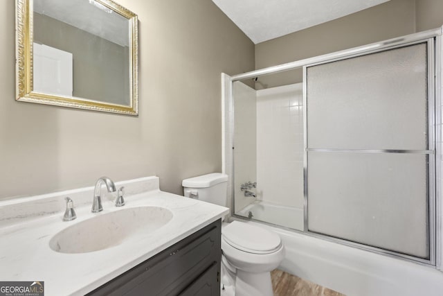 full bathroom with shower / bath combination with glass door, vanity, and toilet