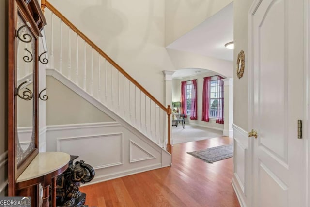 foyer featuring light hardwood / wood-style flooring and ornate columns