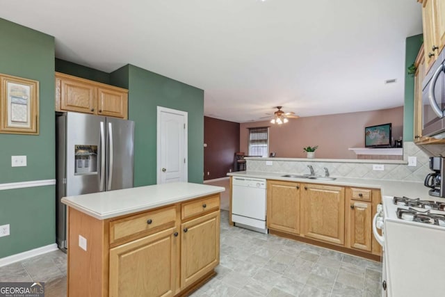 kitchen featuring decorative backsplash, appliances with stainless steel finishes, a center island, and kitchen peninsula