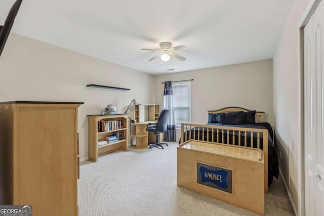 carpeted bedroom with ceiling fan and a closet