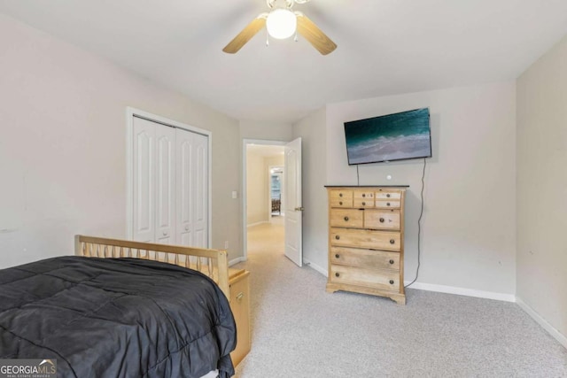 bedroom featuring a closet, ceiling fan, and light colored carpet