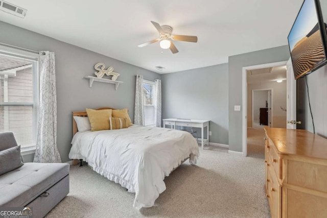 bedroom with ceiling fan and light carpet