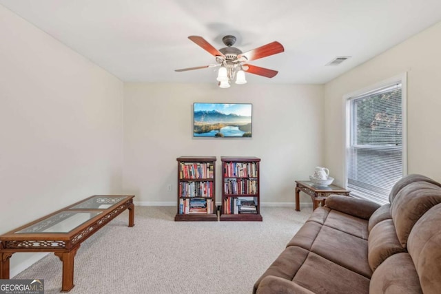 carpeted living room featuring ceiling fan