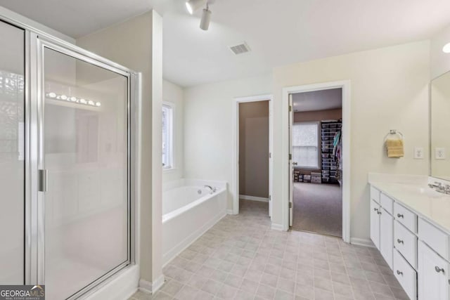 bathroom with vanity and independent shower and bath