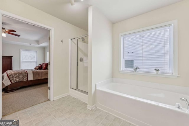 bathroom featuring ceiling fan and plus walk in shower