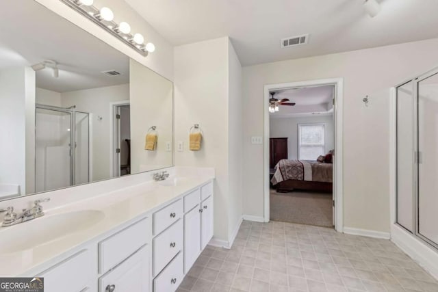 bathroom featuring ceiling fan, vanity, and walk in shower