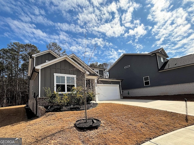 view of front of home with a garage, board and batten siding, and concrete driveway