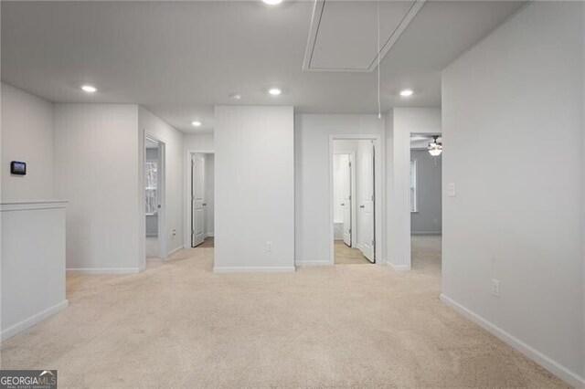 corridor with washing machine and dryer and light colored carpet