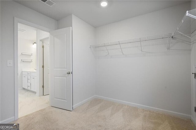 unfurnished room featuring light colored carpet and ceiling fan