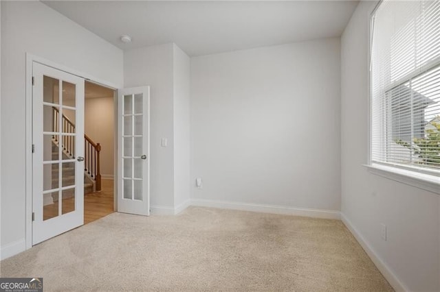 carpeted empty room with french doors