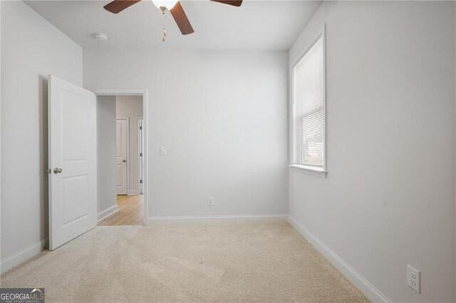 unfurnished living room with ceiling fan, light wood-type flooring, and a high end fireplace