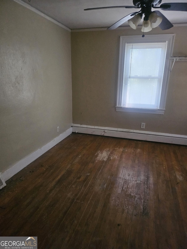 spare room featuring dark hardwood / wood-style flooring, a baseboard radiator, ceiling fan, and crown molding