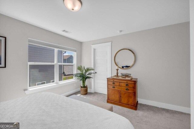 bedroom with light colored carpet