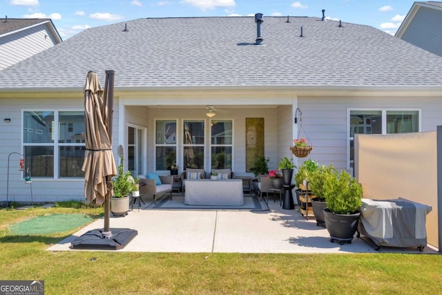 rear view of house featuring ceiling fan, a yard, a patio, and an outdoor living space