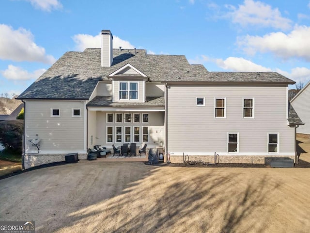 rear view of property featuring a patio area and a yard