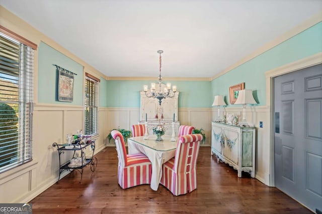 dining area featuring ornamental molding, dark hardwood / wood-style flooring, and a notable chandelier