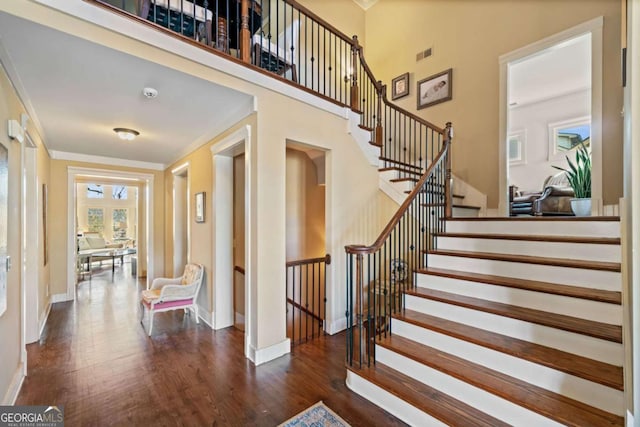 stairway featuring hardwood / wood-style flooring and crown molding