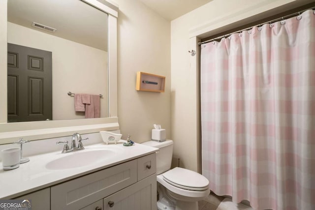 bathroom with walk in shower, vanity, and toilet