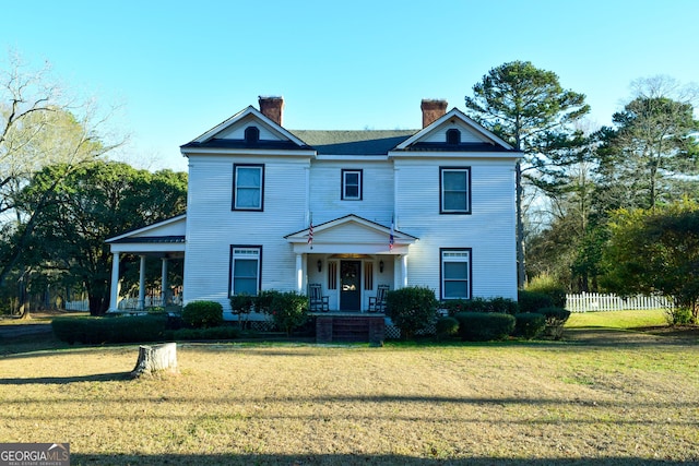 view of front of home with covered porch and a front yard