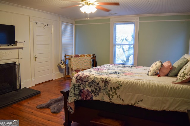 bedroom featuring ceiling fan, crown molding, and hardwood / wood-style flooring