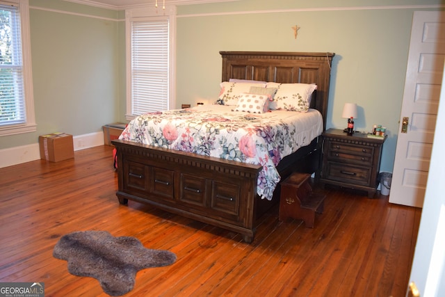 bedroom featuring dark hardwood / wood-style floors and ornamental molding