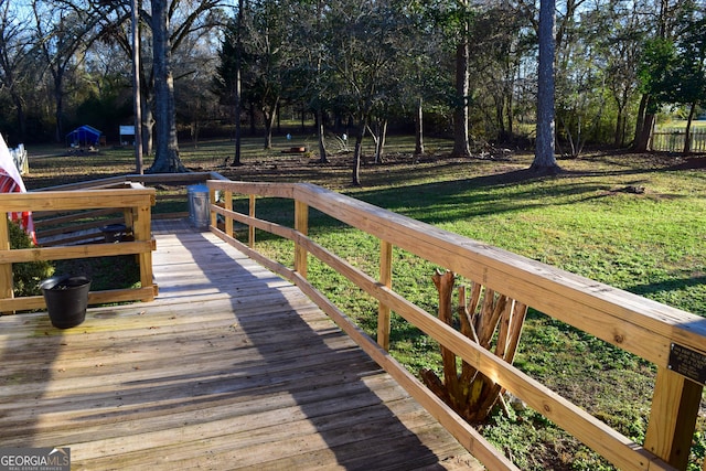 wooden deck with a lawn