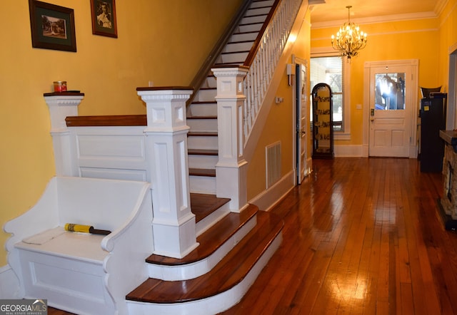 foyer entrance featuring dark hardwood / wood-style floors and an inviting chandelier