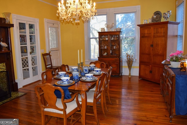 dining area featuring dark hardwood / wood-style flooring and a chandelier