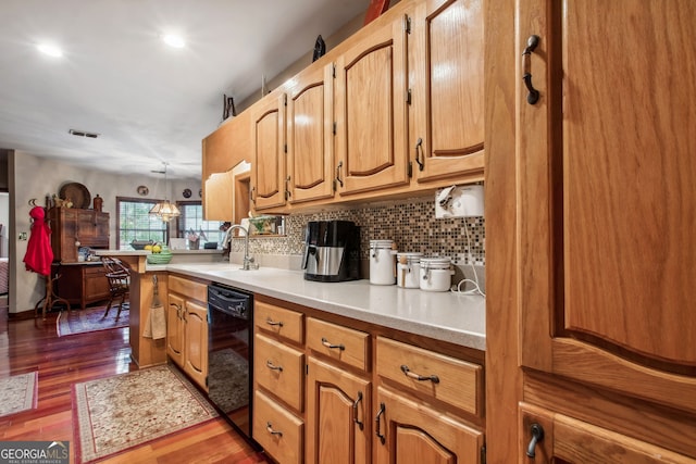 kitchen featuring sink, black dishwasher, tasteful backsplash, dark hardwood / wood-style floors, and decorative light fixtures