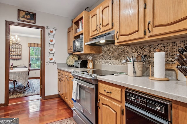 kitchen with stainless steel range, tasteful backsplash, and dark hardwood / wood-style floors