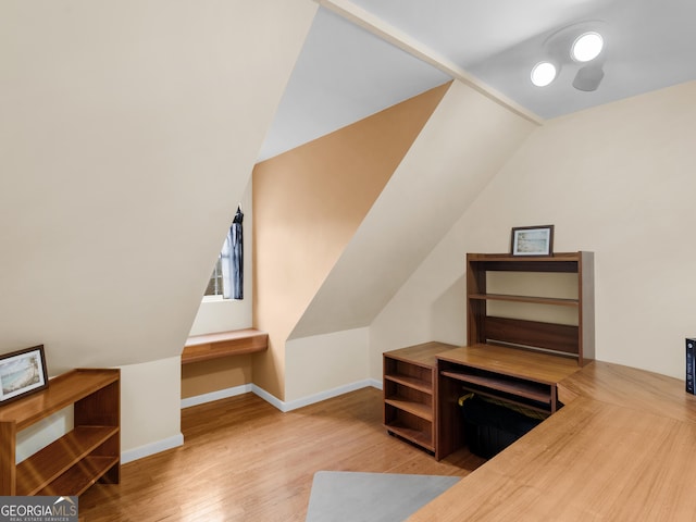 bonus room featuring lofted ceiling and light wood-type flooring