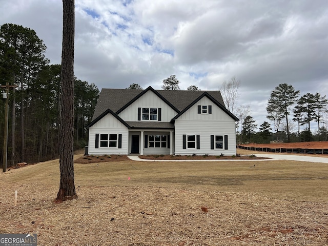 modern farmhouse featuring a shingled roof and board and batten siding