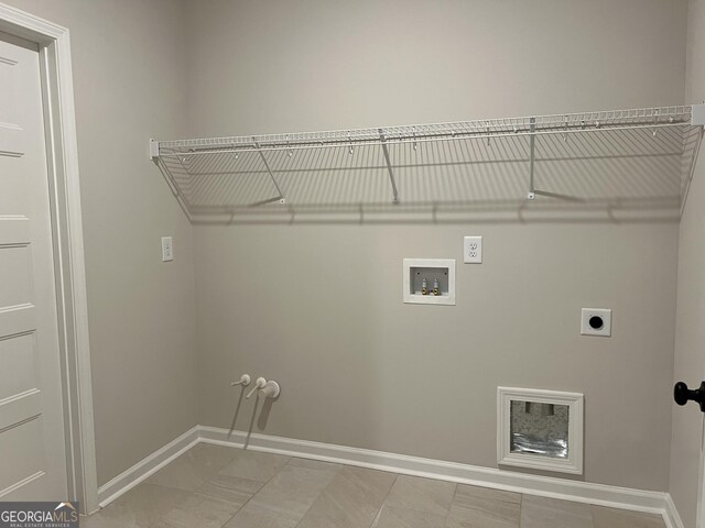 washroom featuring baseboards, hookup for an electric dryer, laundry area, and hookup for a washing machine